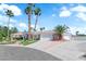 Beautiful single-story home showcasing a well-manicured lawn, mature palm trees, and a three-car garage at 4418 Desert Bloom Ct, Las Vegas, NV 89129