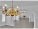 Open-concept living area showcases a view of the fireplace, chandeliers, and pillars at 4418 Desert Bloom Ct, Las Vegas, NV 89129