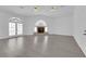 Spacious living room with fireplace, french doors and gray flooring at 4418 Desert Bloom Ct, Las Vegas, NV 89129