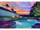 Beautiful pool with an attached hot tub located in a backyard with lush landscaping at 4418 Desert Bloom Ct, Las Vegas, NV 89129