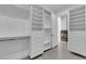 Well-organized walk-in closet featuring built-in shelving, drawers, and hanging racks at 4418 Desert Bloom Ct, Las Vegas, NV 89129