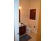 Bathroom featuring a single sink vanity, mirror, toilet and towel rack at 4585 Dean Martin Dr # 205, Las Vegas, NV 89103
