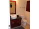 A cozy bathroom featuring a vessel sink, cherry vanity, and modern fixtures at 4585 Dean Martin Dr # 205, Las Vegas, NV 89103