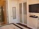 Bedroom with closet featuring sliding doors, a TV and a view of the bathroom at 4585 Dean Martin Dr # 205, Las Vegas, NV 89103