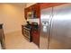Kitchen featuring stainless steel appliances, granite counters, and wooden cabinets at 4585 Dean Martin Dr # 205, Las Vegas, NV 89103