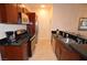 Well-equipped kitchen with stainless steel appliances, tile flooring, granite countertops, and wood cabinetry at 4585 Dean Martin Dr # 205, Las Vegas, NV 89103