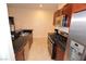 View of the kitchen with stainless steel appliances, granite countertops, and wooden cabinets at 4585 Dean Martin Dr # 205, Las Vegas, NV 89103