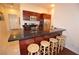 Modern kitchen with stainless steel appliances, granite countertops, a breakfast bar, and wooden cabinets at 4585 Dean Martin Dr # 205, Las Vegas, NV 89103