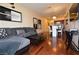 Open floor plan showcasing the wood floors, a gray sectional couch, and views of the dining and kitchen areas at 4585 Dean Martin Dr # 205, Las Vegas, NV 89103