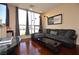 Relax in this living room with large windows and hardwood floors and a gray sectional at 4585 Dean Martin Dr # 205, Las Vegas, NV 89103