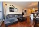 Bright living room featuring wood floors, gray sectional couch, modern decor, and views of kitchen and dining room at 4585 Dean Martin Dr # 205, Las Vegas, NV 89103