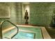 Indoor spa with tiled walls, a statue, and a hot tub at 4585 Dean Martin Dr # 205, Las Vegas, NV 89103