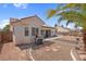 This backyard has a stucco wall, a palm tree, a patio, and a built-in barbecue grill at 4628 Standing Bluff Way, Las Vegas, NV 89130