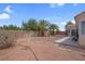 Fully fenced backyard with desert landscaping, concrete patio, and palm trees for a desert oasis at 4628 Standing Bluff Way, Las Vegas, NV 89130