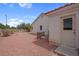 Backyard features desert landscaping, privacy wall, and patio perfect for relaxation or entertaining at 4628 Standing Bluff Way, Las Vegas, NV 89130