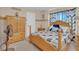 Comfortable bedroom features a wooden bed frame with stylish bedding and a matching dresser at 4628 Standing Bluff Way, Las Vegas, NV 89130