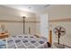 A neutral colored bedroom features a ceiling fan and a large bed with patterned bedding at 4628 Standing Bluff Way, Las Vegas, NV 89130