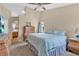 Cozy bedroom featuring neutral walls, ceiling fan, and a comfortable bed with blue patterned bedding at 4628 Standing Bluff Way, Las Vegas, NV 89130
