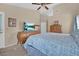 A bright bedroom showcases a comfortable bed, dresser with TV, and natural light at 4628 Standing Bluff Way, Las Vegas, NV 89130