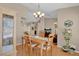 Dining room with hardwood flooring, a chandelier, and views to the adjacent living space at 4628 Standing Bluff Way, Las Vegas, NV 89130