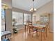 Bright dining room with hardwood floors, decorative chandelier, and large windows with views of the outdoors at 4628 Standing Bluff Way, Las Vegas, NV 89130