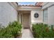 Inviting front entryway with security door, surrounded by mature greenery and a decorative round window at 4628 Standing Bluff Way, Las Vegas, NV 89130