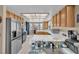 Bright kitchen with white tile countertops, stainless steel refrigerator, and ample natural light from multiple windows at 4628 Standing Bluff Way, Las Vegas, NV 89130