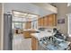 Bright kitchen with white tile countertops, stainless steel refrigerator, and ample natural light from multiple windows at 4628 Standing Bluff Way, Las Vegas, NV 89130