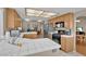 Bright kitchen featuring white tiled countertops, matching backsplash, tile flooring, and stainless steel refrigerator at 4628 Standing Bluff Way, Las Vegas, NV 89130