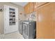 This laundry room features modern washer and dryer, cabinets, and a door shoe organizer at 4628 Standing Bluff Way, Las Vegas, NV 89130