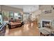Inviting living room with a cozy fireplace, hardwood floors, and abundant natural light from multiple windows at 4628 Standing Bluff Way, Las Vegas, NV 89130