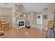 Open-concept living space featuring a fireplace, hardwood floors, and an entryway with tile flooring at 4628 Standing Bluff Way, Las Vegas, NV 89130