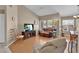 Spacious living room with vaulted ceilings, hardwood flooring, and large windows providing ample natural light at 4628 Standing Bluff Way, Las Vegas, NV 89130