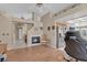 Cozy living area features a fireplace, wood floors, and opens to the kitchen, creating an inviting atmosphere at 4628 Standing Bluff Way, Las Vegas, NV 89130