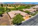 Aerial view of home with mature landscaping, tile roof and proximity to a golf course at 4719 Riva De Romanza St, Las Vegas, NV 89135