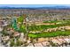 Wide aerial shot of a lush golf course community with beautiful greenery, lakes, and stunning city views at 4719 Riva De Romanza St, Las Vegas, NV 89135