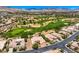 This aerial shot includes a beautiful golf course, well manicured lawns, and a large house at 4719 Riva De Romanza St, Las Vegas, NV 89135