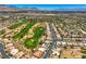 Gorgeous aerial view of a desert neighborhood with a golf course and mountain views in the distance at 4719 Riva De Romanza St, Las Vegas, NV 89135
