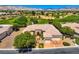 Stunning aerial view of a home on a golf course, showcasing its tile roof and lush landscaping at 4719 Riva De Romanza St, Las Vegas, NV 89135