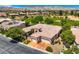 Residential aerial shot featuring the house, three-car garage, landscaping and nearby golf course at 4719 Riva De Romanza St, Las Vegas, NV 89135