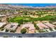 Panoramic aerial view of a desert golf community with mountain views and well-maintained landscaping at 4719 Riva De Romanza St, Las Vegas, NV 89135