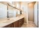 Bathroom featuring a double sink vanity and decorative mirrors at 4719 Riva De Romanza St, Las Vegas, NV 89135
