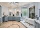 Bright bathroom featuring a soaking tub, dual vanities, and decorative tile accents at 4719 Riva De Romanza St, Las Vegas, NV 89135