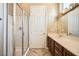 Bathroom featuring a glass shower and a vanity with decorative mirrors at 4719 Riva De Romanza St, Las Vegas, NV 89135