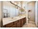 Bathroom featuring a double sink vanity and decorative mirrors at 4719 Riva De Romanza St, Las Vegas, NV 89135