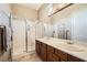 Modern bathroom featuring a glass shower, double sinks, and stylish fixtures at 4719 Riva De Romanza St, Las Vegas, NV 89135