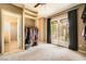 Bright bedroom with a walk-in closet and French doors leading to the outside at 4719 Riva De Romanza St, Las Vegas, NV 89135