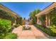 Inviting courtyard featuring lush greenery, a bench, and a walkway leading to the entrance at 4719 Riva De Romanza St, Las Vegas, NV 89135