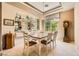 Bright dining room boasts a stunning display cabinet and a classic grandfather clock at 4719 Riva De Romanza St, Las Vegas, NV 89135