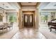 Elegant foyer with high ceilings, tiled floors, and a view of the formal dining and living areas at 4719 Riva De Romanza St, Las Vegas, NV 89135